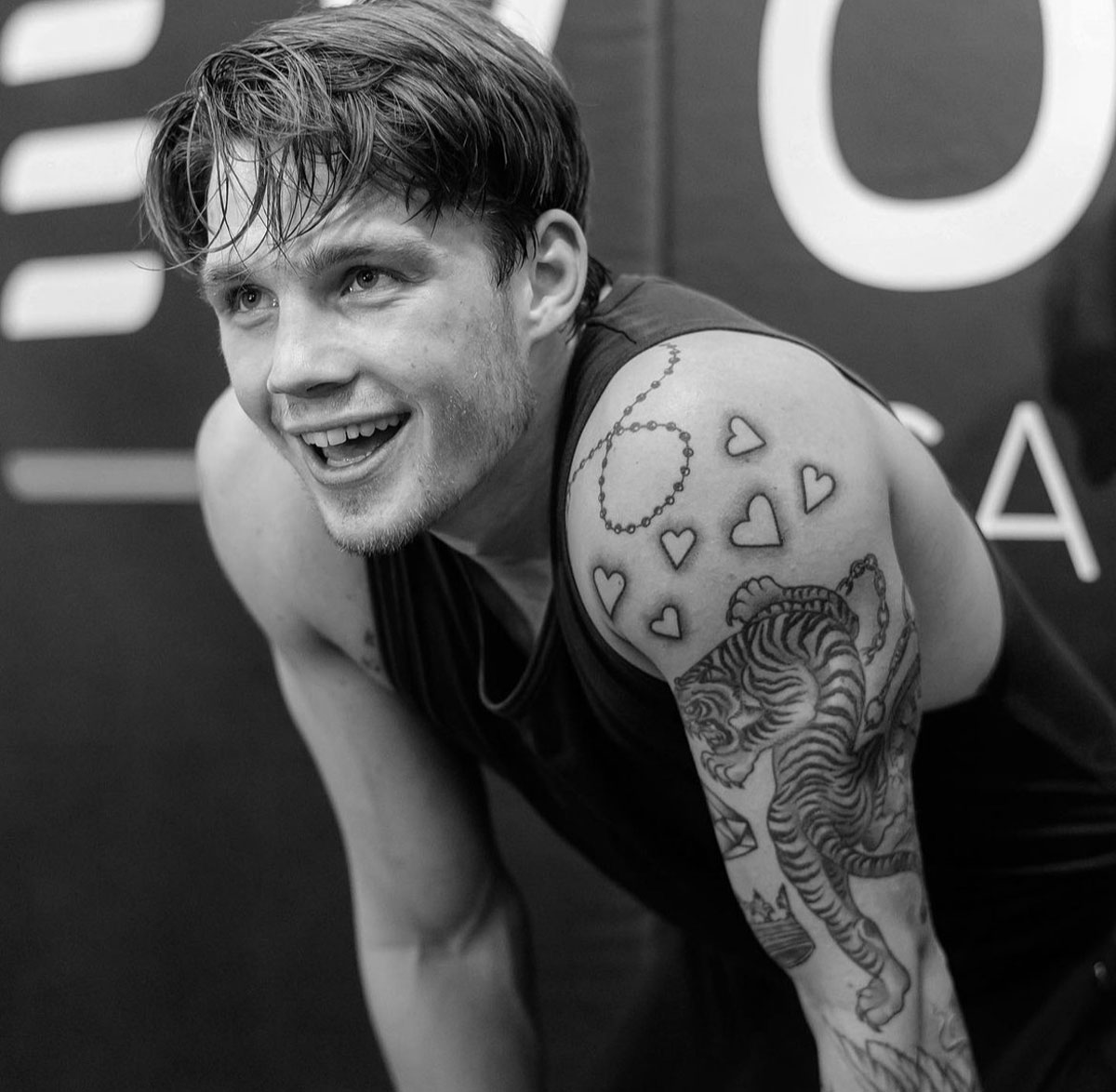 Coach after a workout, smiling in black & white photo.